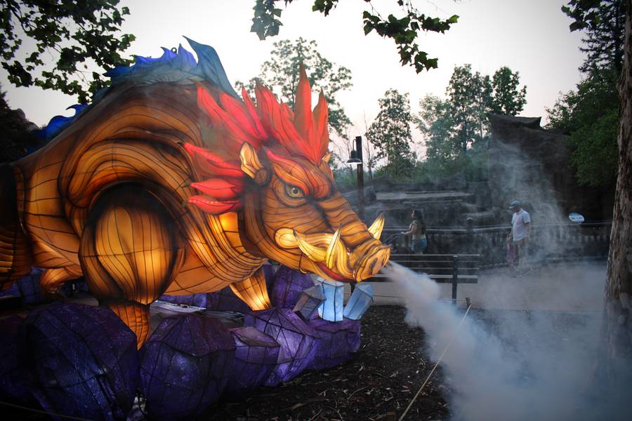A boar lantern blows smoke out of its nose.
